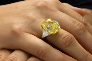J. Birnbach 20.06 ct GIA Fancy Intense Yellow Cushion Diamond Three-Stone Ring